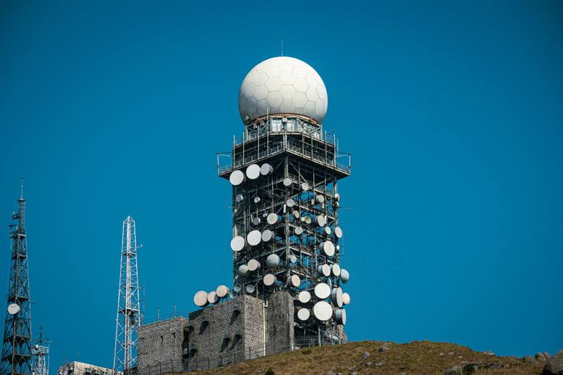 A radar dome and masts on a hill