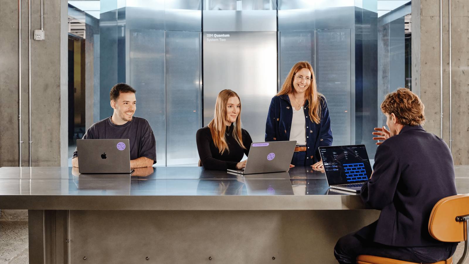A team at work in front of an IBM Quantum System Two